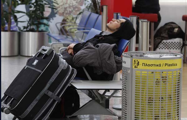  A stranded traveler sleeps on a chair in Athens airport after her connection flight was canceled due to a 24-hour air traffic controllers' strike, part of a civil service walkout against wage freezes on Wednesday, Feb. 10, 2009. Thousands of civil servants and Communist Party-affiliated workers gathered in Athens and Thessaloniki, Greece's second-largest city, Wednesday for demonstrations against the center-left government's austerity plan to ease Greece out of a major debt crisis that has alarmed European Union partners and international markets, weakening the euro.  