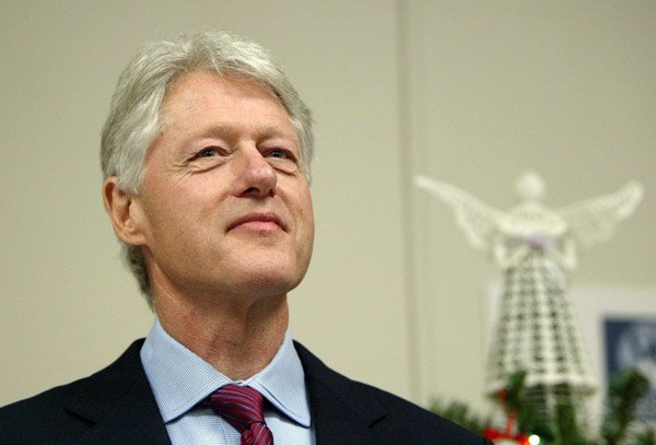 In this Dec. 23, 2004 file photo Former President Bill Clinton waits his turn at the podium before formally thanking the staff at Westchester Medical Center, in Valhalla, N.Y. for diagnosing the heart condition that led to his quadruple bypass surgery in August.