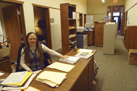 Desk clerk Josephine Barry works among disp laced office furniture and equipment that had to be moved because of a water-line break at the Hobbs State Park-Conservation Area visitor center. The break occurred in January and damaged the office area, but visitors shouldn’t notice anything awry when they tour the center.
