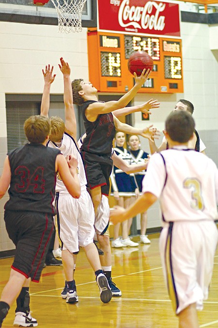 Dayton Winn, junior Blackhawk, went up for a shot in the first quarter of the recent District tournament game against Shiloh. The ’Hawks lost 28/43.