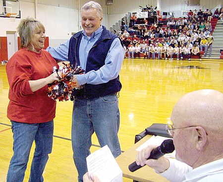 School superintendent Mike Van Dyke presented Kim Brown with a pom pom as honorary cheer captain for the Senior Night basketball game Feb. 6.