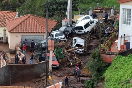 Cars are seen piled up among houses on a hillside outside Funchal, the Madeira Island's capital, Saturday.