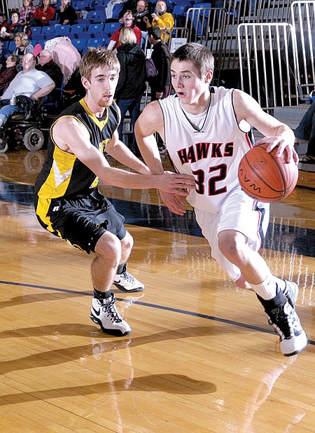 Blackhawk Kasey Cooper (32) worked around defending Prairie Grove’s Tanner Gallman during Wednesday night’s District tournament game at Shiloh. The ’Hawks won that contest, only to lose to Farmington Friday night. The ’Hawks are scheduled to play in the Regional tournament Thursday.