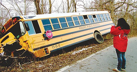 Morgan Bowen, 15, a sophomore at Heritage High School was one of six students on a Rogers school bus which wrecked on Ventris Road Friday morning. Morgan took a photograph of the bus with her cell phone.