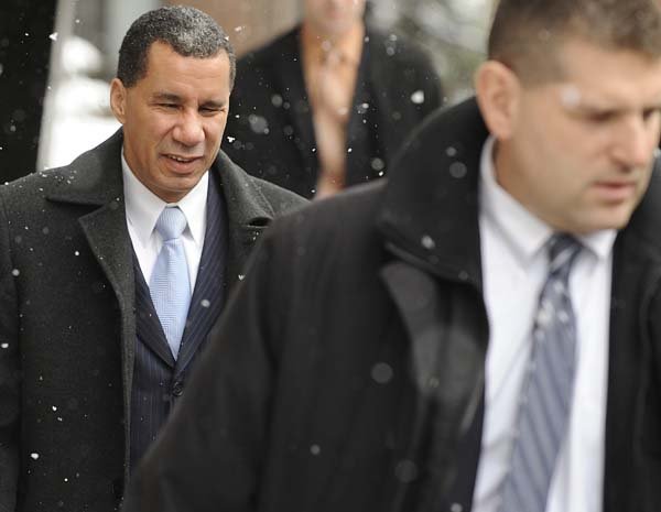  New York Gov. David Paterson, left,  escorted by security, leaves his apartment en route to a news conference where he was to announce he is  not going to run for another term as governor, Friday Feb. 26, 2010 in New York. 
