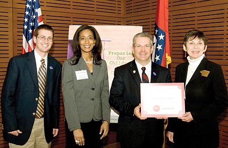 SCHOOL RECEIVES HONORS - Keith Martin, principal of Pea Ridge Elementary School, (left) and Anita Wood, principal of Pea Ridge Intermediate School, (far right) received an award recently in Little Rock as a Just for the Kids Higher Performing School in the area of mathametics.
