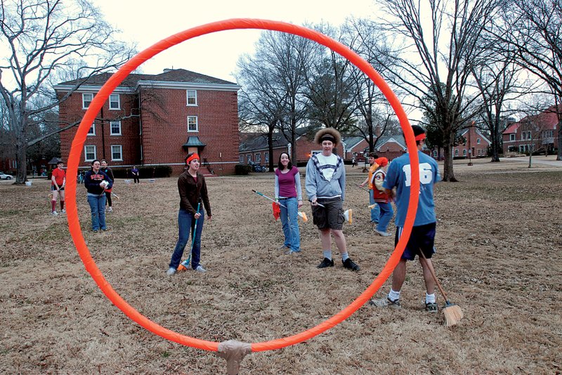 Ed Crews (puffy hair and black headband), co-organizer of the Hendrix Quidditchers, bears down upon the Keeper of the Team Orange Headbands hoop, Dmitriy Nurullayev, as orange headbanders saunter menacingly nearby.