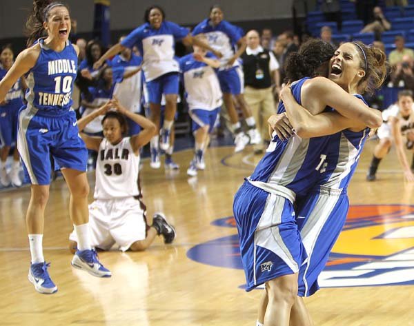  Middle Tennessee women's basketball team member Anne Marie Lanning, right, hugs Alysha Clark as teammate Jackie Pickel 