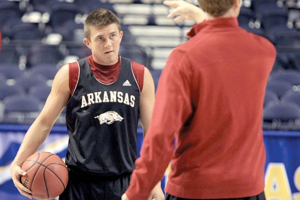    Arkansas player Rotnei Clarke listens to coach John Pelphry during practice Wednesday afternoon at the Southeastern Conference tournament in Nashville, Tenn. 