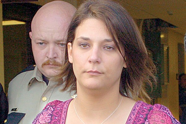 Sheriff’s Deputy Jeremy Kissire escorts Amber Turley from the Conway County Courthouse in Morrilton after she pleaded guilty Tuesday to felony child endangerment.
