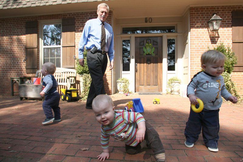 Congressman Vic Snyder, D-Ark., plays with his 15-month old triplets' (left to right) Sullivan, Wyatt and Aubrey, outside their Little Rock home, March 5.
