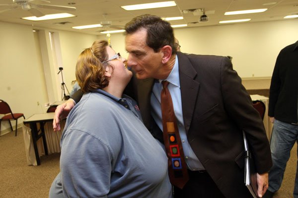 Cindy Wise, wife of slain Salvation Army Major Philip Wise, greets North Little Rock Police Chief Danny Bradley on Tuesday afternoon after Bradley announced an arrest in the case.