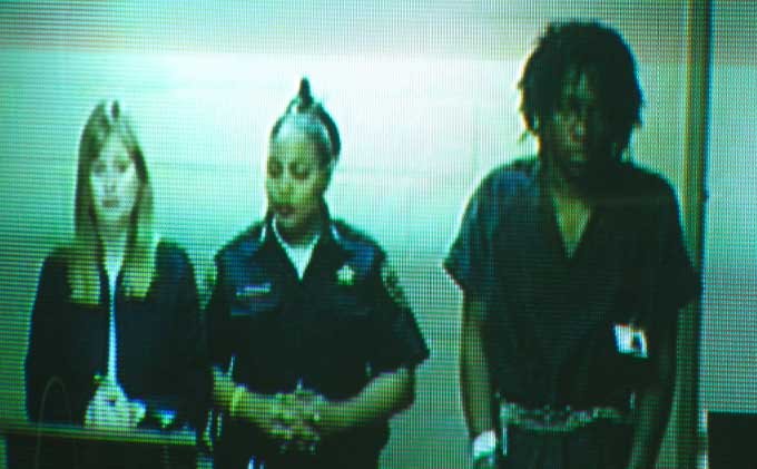 Laquan Fitzpatrick, far right, appears via video in North Little Rock District Court this morning.