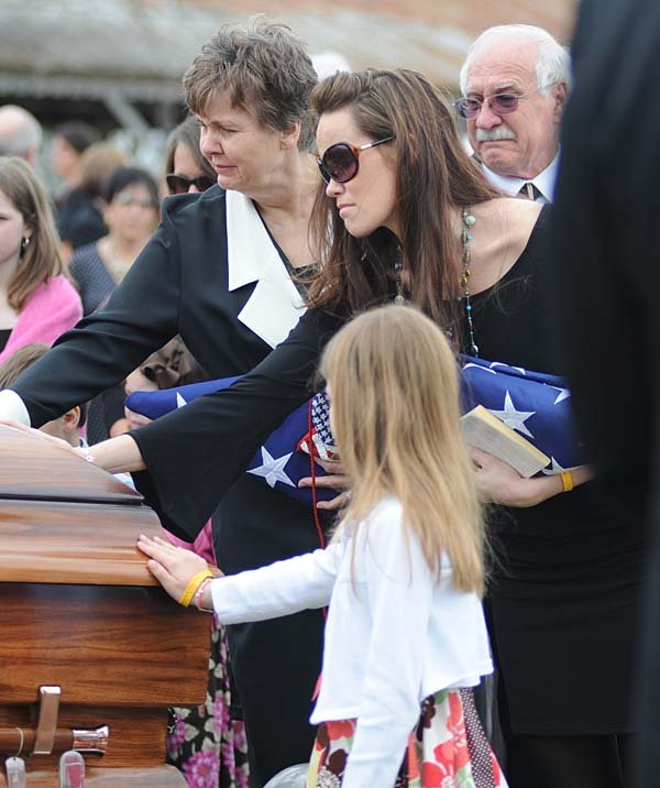  Mother Janice Brown of Hot Springs, left, widow Kelley Brown, daughter Savannah Brown, front, and father Larry Brown, back right, of Hot Springs say goodbye to U.S. Navy Chief Special Warfare Operator Adam Lee Brown, 36,  at Cunningham Cemetary in Royal Wednesday, March 24, 2010, during a graveside service. Adam Brown was killed during combat operations in support of Operation Enduring Freedom in Afghanistan. B