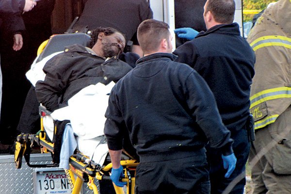 Floyd Walton, who was shot by Little Rock police Friday morning during a no-knock raid at a Marshall Street apartment, is loaded into an ambulance. Walton and an unidentified woman were shot as officers tried to execute a search a warrant.