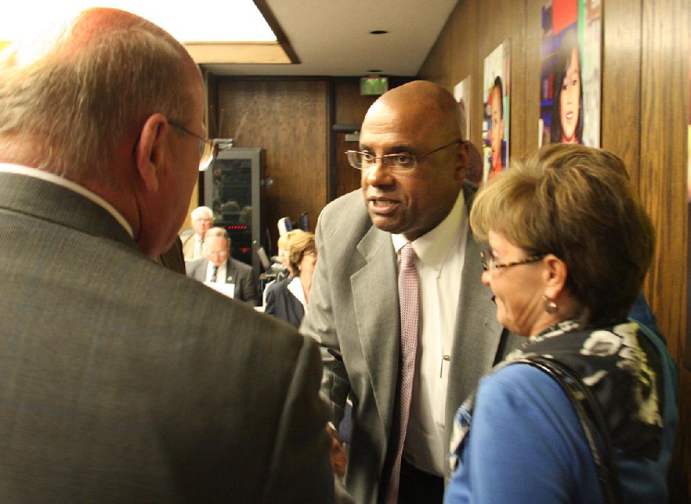 Arkansas Democrat-GazetteRICK MCFARLAND--041210-- Don Johnston (left), superintendent, Marion School District, shakes hands with Alfred Hogan, superintendent Turrell School District, after the state Board of Education voted to consolidate Turrell School District with the larger Marion School District. Robin Catt, director of Human Resources for the Marion district is shown (right).