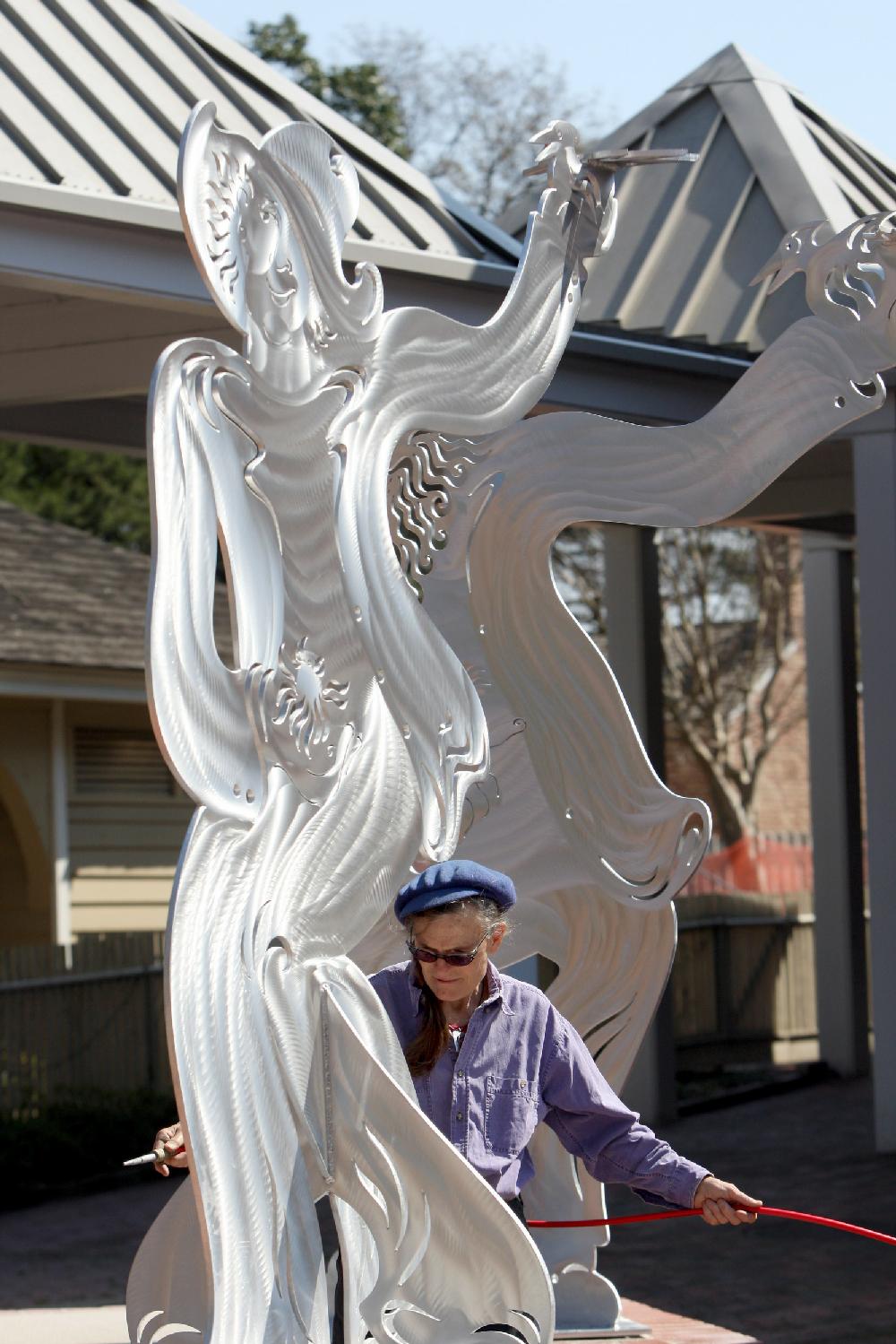 3222010Arkansas Democrat-GazetteSTEPHEN B. THORNTONArtist Alice Guffey Miller uses an airhose to dust off a piece of her sculpture titled "pARTy for PEG" being installed Monday afternoon at the Historic Arkansas Museum.