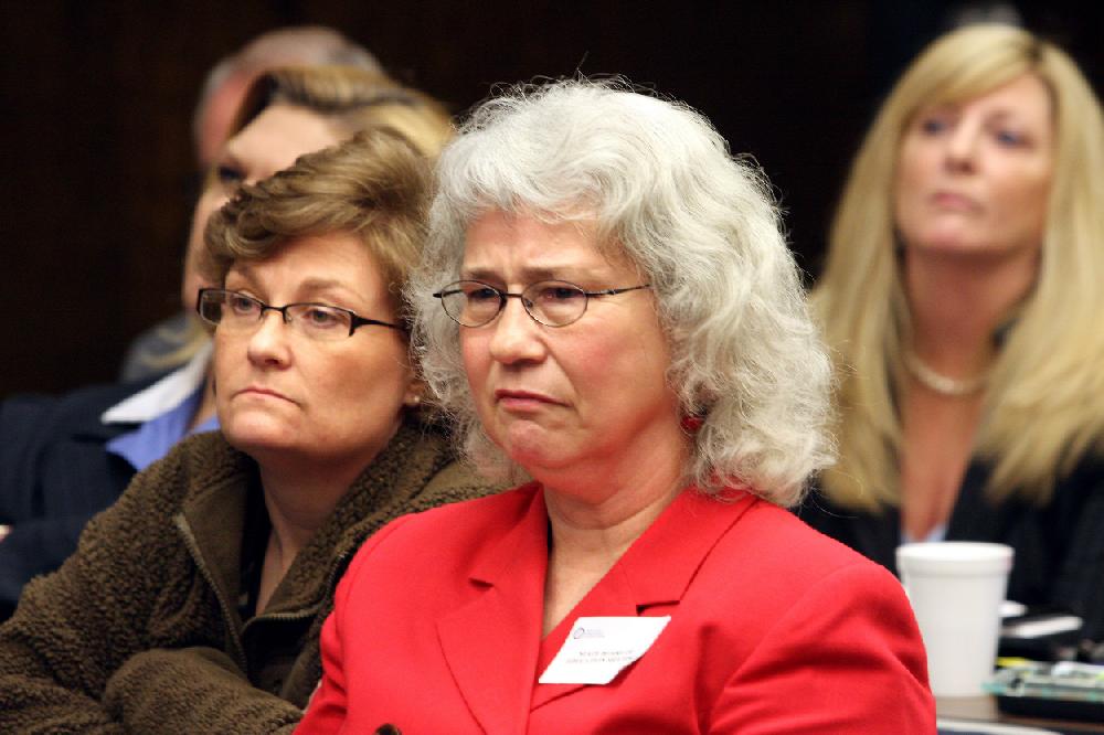 Arkansas Democrat-GazetteRICK MCFARLAND--041210-- Vicky Williams (right), interim director School of Excellence Charter School in Humphrey, and Angie Davis (left), a student's parent, listen Monday in Little Rock as the state Board of Education votes to close the school immediately. The school has 39 students.