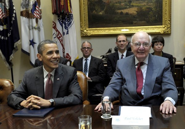President Barack Obama sits next to Paul Volcker, chairman of the President's Economic Recovery Advisory Board, during a meeting in the Roosevelt Room of the White House in Washington on Friday.