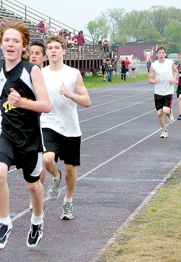 Jr. Blackhawk track members Dayton Winn, third from left, and Justin Samples, right, competed at Gentry Friday.
