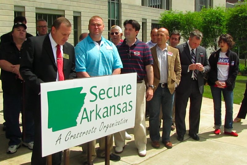 Members of Secure Arkansas announce a lawsuit challenging the constitutionality of a health bill during a Tuesday news conference.