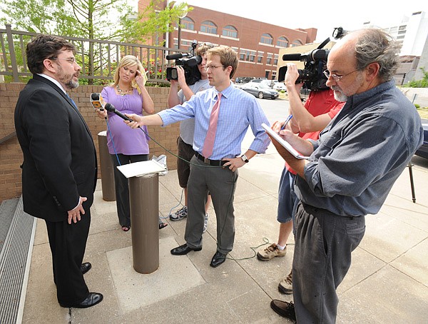 West Doss, attorney for Billy Wolfe, speaks to members of the media following the announcement of the verdict in his client's harassment lawsuit against the Fayetteville School District.