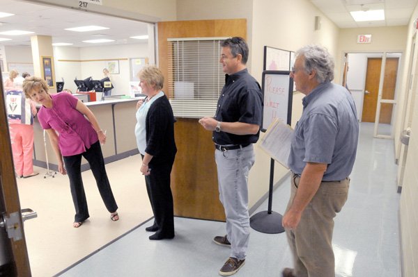 A line of early voters begins to form again after lunchtime Monday outside the doors of the Benton County clerk’s office in Bentonville. Early voting ended at 5 p.m. Monday.