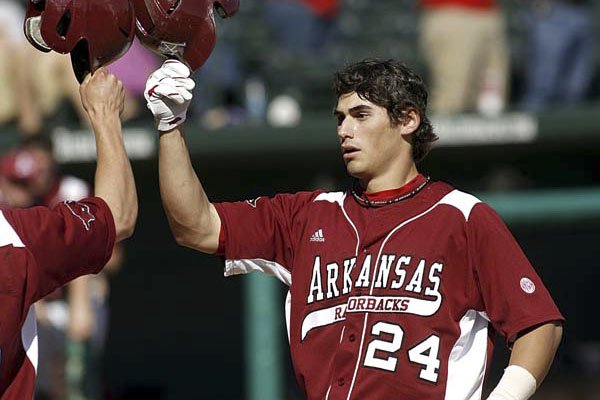 Arkansas' Brett Eibner, who hit a pair of doubles and scored a run at the plate in a 5-2 loss Tuesday at Oklahoma, celebrates with teammate Travis Sample after hitting a two-run home against Centenary earlier this season.