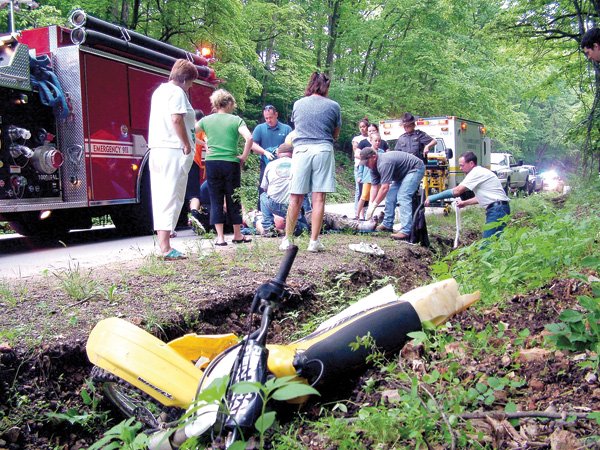 A Suzuki dirt bike lays in the ditch after the driver, Kris Bolin of Avoca, was thrown off. Bolin was treated at the scene by emergency personnel from VAS Ambulance Service Corp. before being to the hospital.