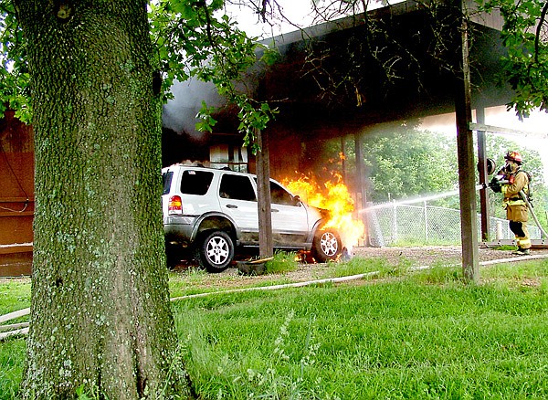 Flames engulfing the 2004 Ford Escape reached toward the ceiling of the carport of the home of Orville and Maureen Haas at 3540 Hayden Road. Smoke billowed into the sky. Pea Ridge firefighters arrived on the scene shortly after noon Monday. Firefighter John Bobholz quickly extinguished the flames as other firefighters manned the pump and checked the house for signs of fire. The vehicle was destroyed but the home was saved. “You are a blessing,” Mrs. Haas told the firefighters.
House saved
