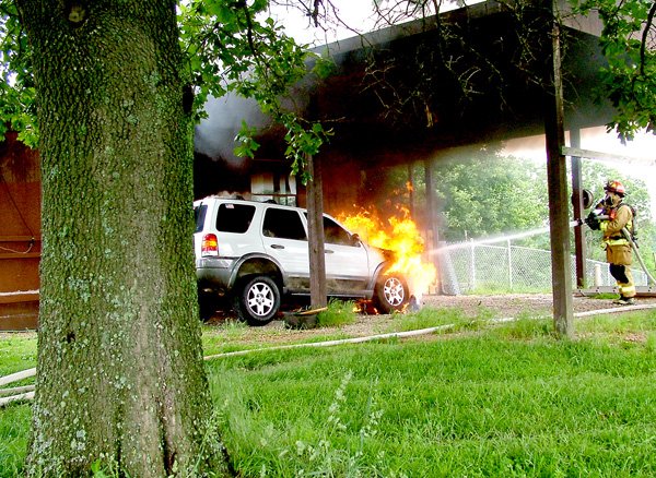 Flames engulfing the 2004 Ford Escape reached toward the ceiling of the carport of the home of Orville and Maureen Haas at 3540 Hayden Road. Smoke billowed into the sky. Pea Ridge firefighters arrived on the scene shortly after noon Monday. Firefighter John Bobholz quickly extinguished the flames as other firefighters manned the pump and checked the house for signs of fire. The vehicle was destroyed but the home was saved. “You are a blessing,” Mrs. Haas told the firefighters.
House saved
