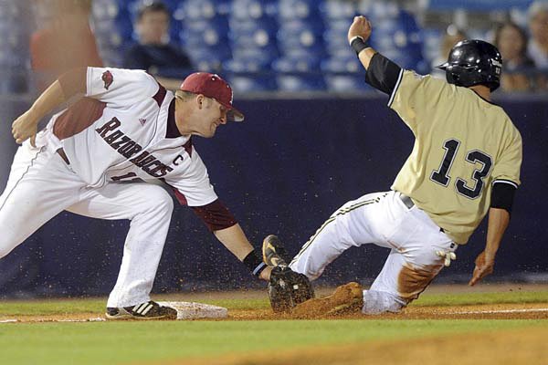 Arkansas third baseman Andy Wilkins tags out Vanderbilt’s Anthony Gomez as he tries to advance to third on a ball in the dirt in the third inning Wednesday at the SEC Tournament in Hoover, Ala. 