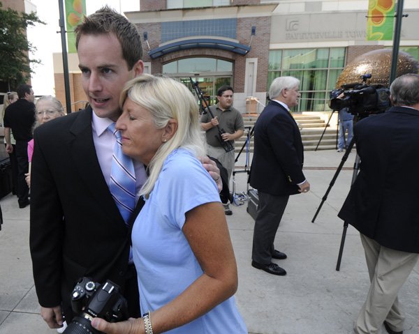 Jared Greer of Fayetteville hugs his mother-in-law, Angela Lehren, after a news conference Wednesday to announce that Greer and his wife, Sarah, are the winners of a TCBY franchise.