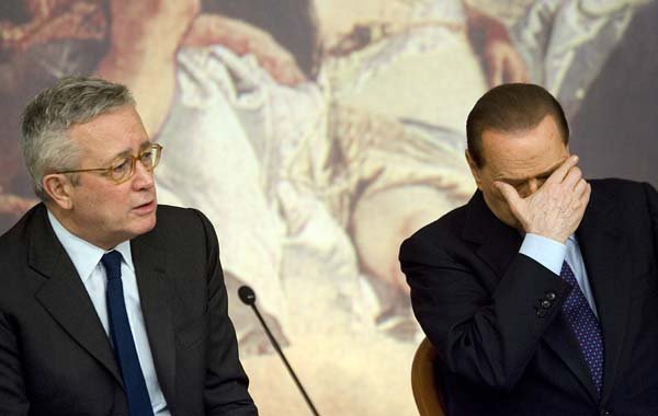 Italian Premier Silvio Berlusconi (right) and Economy Minister Giulio Tremonti attend a news conference Wednesday in Rome to explain new austerity measures.