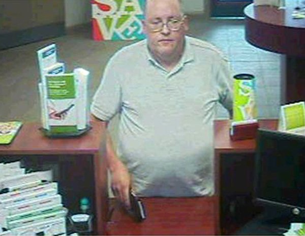 This May 18, 2010, security photo provided by the FBI on Tuesday, June 1, 2010, shows a man the FBI has named the "Granddad Bandit," in St. Louis County, holding a black billfold with a holdup note.