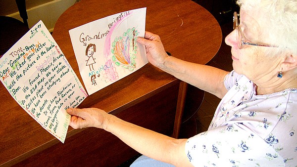 Marilyn Briggs looks fondly on letters and drawings she received from Mrs. Laura Elrod’s second grade class in 1999. Those students graduated this year.