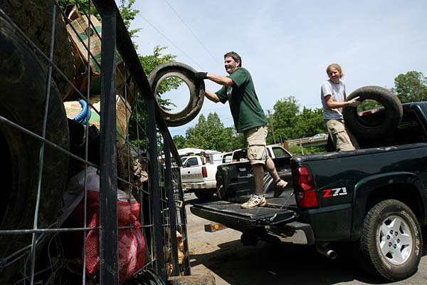  Arkansas Democrat-Gazette/William Moore
John Mathis and Jane Maginot, both of West Fork, throw old tires into a trailer to be taken to the Boston Mountain Solid Waste District while participating in the West Fork White River Clean Up Saturday, June 5, 2010 at West Fork Riverside Park on the West Fork of the White River.  The clean up was organized by the West Fork Watershed Alliance, with help from, among many, the University of Arkansas Division of Agriculture Cooperative Extension Service, and Beaver Water District.  Maginot was there with the UA Cooperative Extension, and Mathis was there on his own.  Around 125 people participated in the event, with over 70 of those being people who went out and collected trash.