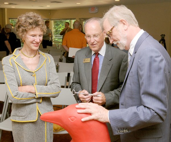 Laura Lee Brown, from left, Mayor Bob McCaslin and Steve Wilson from 21c Museum Hotels talk Tuesday following a news conference at Compton Gardens in Bentonville. Wilson announced plans for a 21c Museum Hotel near the northeast corner of Bentonville square. The 4-foot-tall red plastic penguin is part of a moving exhibit at the 21c Museum Hotel in Louisville, Ky.
