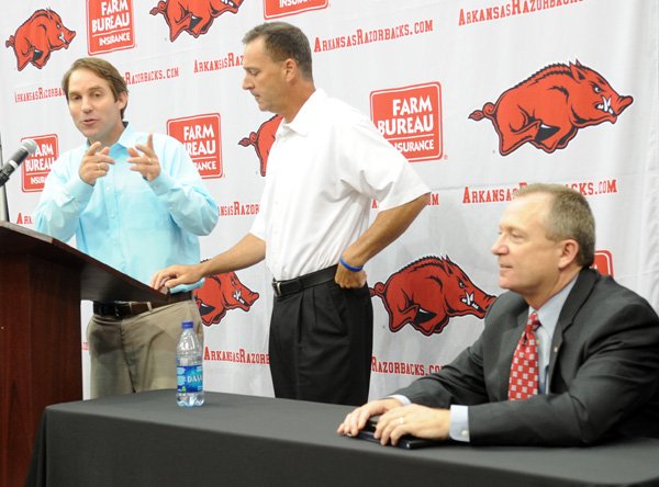 Rich Morris (from left) and ESPN sportscaster Jimmy Dykes, both University of Arkansas graduates, and Athletic Director Jeff Long talk Friday about a Haitian earthquake aid project.