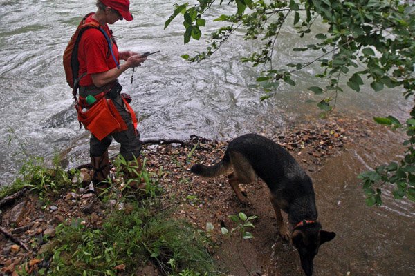 Georgia Baker and her cadaver dog Zoe search along the banks of the Little Missouri River north of Highway 84 northwest of Langley Sunday afternoon as the search for victims of the flood of the Albert Pike Campground continues.