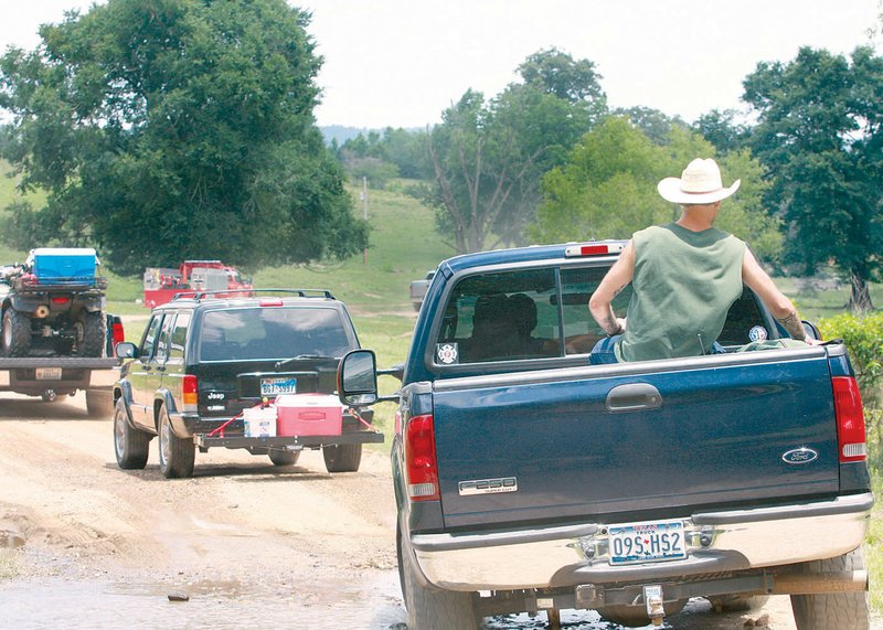 Volunteer searchers from Texas head Monday to a spot near Langley, south of the Albert Pike Recreation Area.