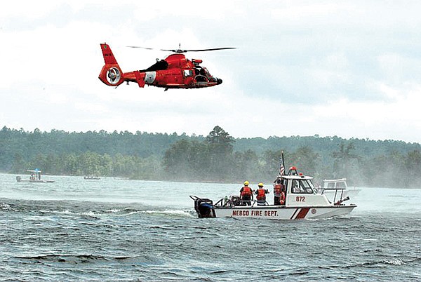 Left, the NEBCO crew worked with members of the U.S. Coast Guard helicopter crew in transfering victims to the helicopter basket.  “Each year we send at least three of our guys down for fireboat training. We do have two boats on the lake for boat or dock fires or water rescue,” Fire Chief Rob Taylor said. “I think it’s fantastic that our firefighters are willing to do this and take on the extra training.”