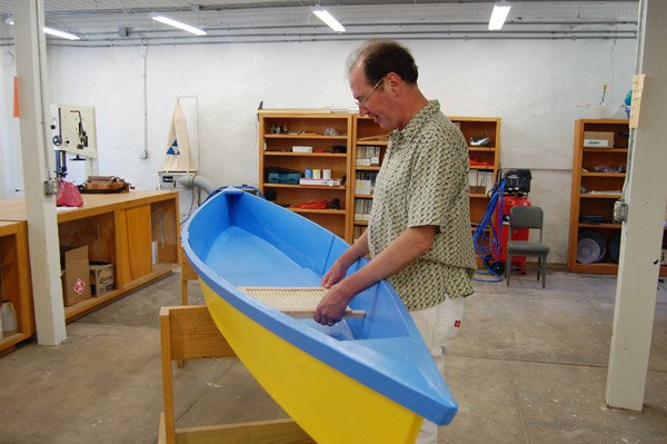 John Van Orman positions the traditional seat for the pirogue he made during the boat-building class he taught at the Arkansas Craft School in Mountain View. Van Orman chose to paint his flat-bottom boat yellow and blue, which depicts the colors in the Flag of Ukraine. The yellow/gold color represents the fertile golden fields, and the blue represents the sky. Van Orman spent two summers in the Ukraine studying its traditional music.