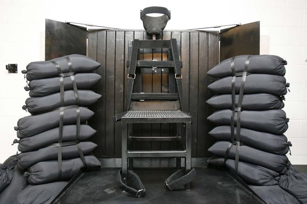 The execution chamber at the Utah State Prison after Ronnie Lee Gardner was executed by firing squad Friday, June 18, 2010. The bullet holes are visible in the wood panel behind the chair. Gardner was convicted of aggravated murder, a capital felony, in 1985.
