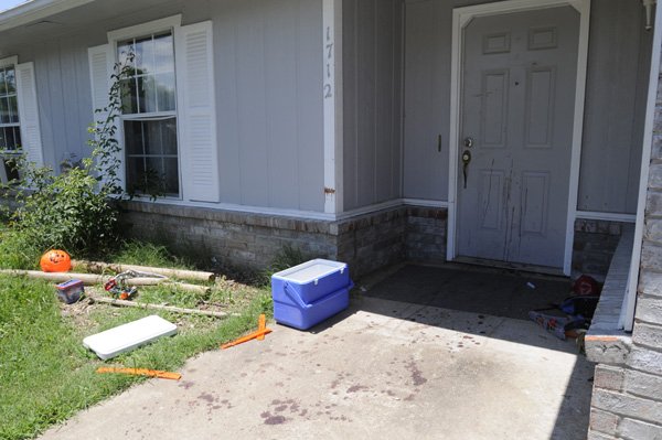 Blood trails lead into a house at 1712 S. H St. in Rogers where two men were stabbed after a fight early Friday. One was killed and the other is in critical condition at Mercy Medical Center.