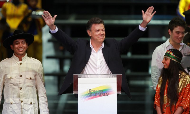 President-elect Juan Manuel Santos greets his supporters as he arrives to give his victory speech after winning the presidential election runoff in Bogota, Sunday, June 20, 2010. Santos defeated Green Party candidate Antanas Mockus. 