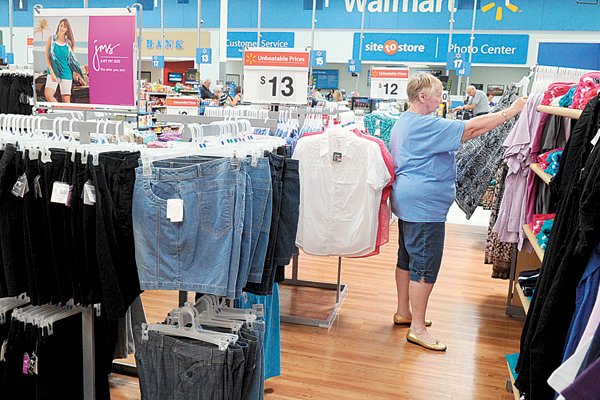 Shirley Furlan of Fayetteville browses through blouses Thursday in the apparel department of the Wal-Mart Supercenter on North Mall Avenue in Fayetteville.