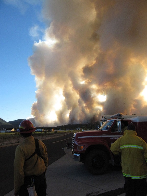 Fire crews watch as a wildfire burns north of Flagstaff, Ariz., Sunday, June 20, 2010. 