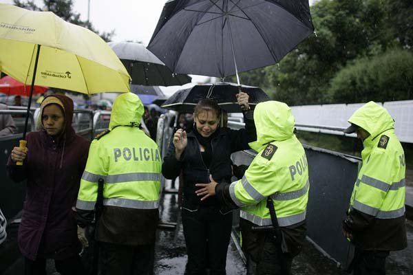 Police search voters at a polling station in Bogota during the Colombian presidential election runoff Sunday.
