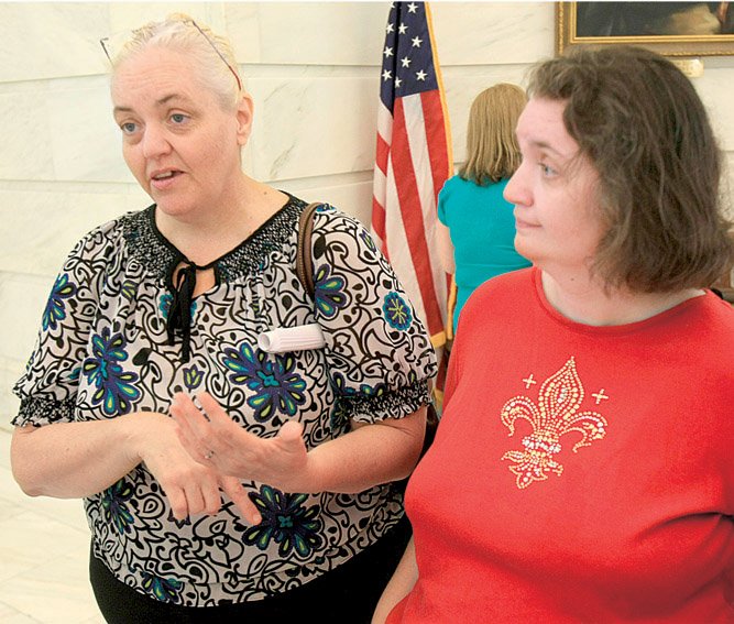 Ina Bailey (left) speaks about her sister, Christina Board, (right) a former Booneville Human Development Center resident, after a Tuesday news conference in which some advocates for the disabled called on Gov. Mike Beebe to close the facility.